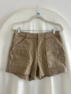 Taupe / Tan vintage cargo mini shorts by L.L. Bean, Sportif USA Lots of pockets! A few small spots on the front-- see photos. Good used condition. 62% Polyester, 34% Cotton, 4% Spandex Measurements: Waist: 30" Hips: 40" Rise: 10" Inseam: 5" Outseam: 14.5" Utility High-waisted Cargo Shorts With Patch Pockets, Khaki Cargo Shorts With Multiple Pockets, High-waisted Utility Cargo Shorts With Patch Pockets, High Waist Utility Cargo Shorts With Hip Pockets, Utility High-waisted Shorts With Side Pockets, High-waisted Cargo Shorts With Patch Pockets, High Waist Utility Shorts With Side Pockets, High-waisted Utility Shorts With Side Pockets, Khaki Utility Shorts With Hip Pockets