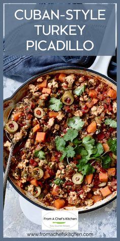 a pot filled with meat and vegetables on top of a white table next to a blue towel