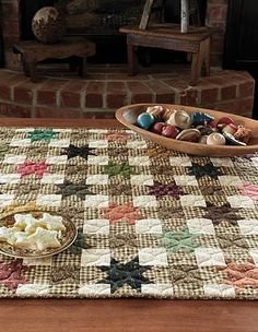 a table topped with a plate of food on top of a wooden table next to a fire place