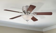 a ceiling fan with two wooden blades and a light fixture on it's side