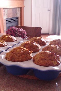 muffins are sitting in blue dishes on a table