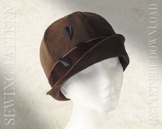 a white mannequin head wearing a brown hat