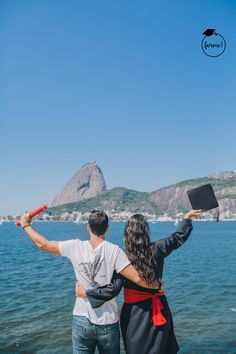 a man and woman looking at the water