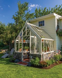 a house with a small greenhouse in the front yard