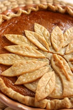 a close up of a pie with leaves on it