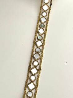 a close up of a bracelet on a white surface