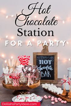 hot chocolate station for a party with candy canes and marshmallows on the table