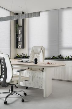 an office desk with two chairs and a planter in the corner next to it