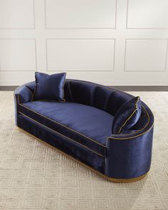 a blue couch sitting on top of a rug