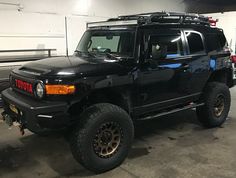 a black toyota truck parked in a garage