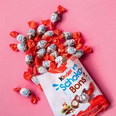 a bag of kinder's chocolates on a pink background