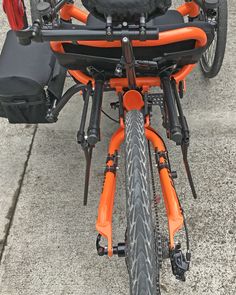 an orange and black motorcycle parked on the street