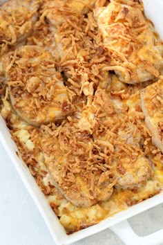 a casserole dish with chicken and cheese in it