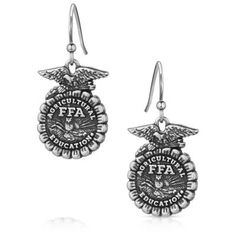 Show your love for the FFA Organization with the FFA Emblem Earrings. The earrings feature an etched FFA emblem in an antiqued silver tone. The earrings depict the FFA emblem in stunning detail. An etched eagle sits atop the cross section of corn. Through the center "Agriculture Education" and "FFA" are clearly visible. The rising sun serves as the backdrop for the plow and owl in the center. These earrings will make the perfect gift to any FFA member, advisor, and alumni in your life. The earrings are secured by hypoallergenic French wires. Earrings have French wires for easy wear. All Montana Silversmiths jewelry and accessories are coated with Montana Armor to prevent tarnish. These earrings have french wires for easy wear. Celebrate our future farmers with the FFA emblem. A silver fini Ffa Emblem, Montana Silversmith Jewelry, Agriculture Education, The Rising Sun, Cross Section, Ffa, Tractor Supply, Our Future, French Wire