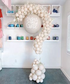 the balloon arch is decorated with white balloons