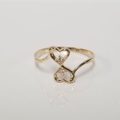 "Thanks for shopping our vintage estate store. We tend to sell well below wholesale and truly hope you enjoy all of our items. Many of the items are one of a kind, so please enjoy scrolling through the pictures and hopefully something will catch your eye. Black spots are from reflections. Estate 14k yellow gold heart to heart cz diamond by pass ring. Cz diamonds are .01ct each. Ring size: 7.25 Setting: 4mm 1/4\" by 1/2\" Band width: 1mm Weight: 1.02 grams Marked 14k. Sweet ring. As with most est Affordable Gold Heart Promise Ring, G Ring, Gold Heart Rings, Cute Gold Heart Promise Ring, Gold Ring Heart, Vintage Yellow Gold Heart Ring For Formal Occasion, Heart Rings, Vintage 14k Gold Heart Ring, Tulip Ring