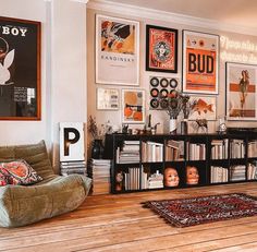 a living room filled with lots of furniture and pictures on the wall next to a book shelf