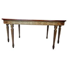 an ornately decorated console table with two legs