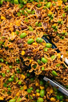 a plate full of noodles with peas and meat