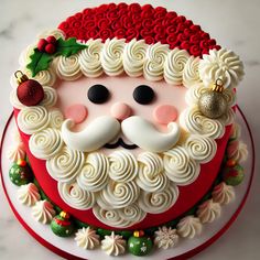 a christmas cake decorated with white icing and santa claus's face on top