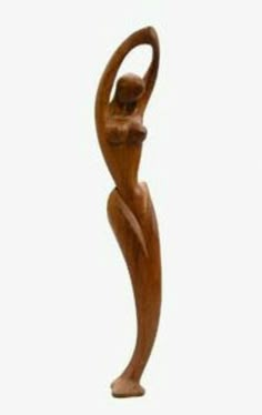 a wooden sculpture is shown against a white background with the image of a woman holding her arm up