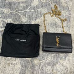 This Purse Is Like New. There Are No Stains, Scratches Or Tears. This Purse Does Not Have A Tassel. The Dust Bag Is Included. Size Info 8"W X 5 ¼"H X 2"D. (Interior Capacity: Small.) Details & Care Polished Goldtone Accents Add Timeless Shine To A Calfskin Bag Featuring A Gilded Pull-Through Chain Strap And Interlocking Logo Hardware. Magnetic Snap-Flap Closure Pull-Through Chain Strap Interior Wall Pocket Leather Made In Italy Designer Handbags Bags Ysl, Ysl Kate, Yves Saint Laurent Bags, Pull Through, Small Details, Interior Wall, Small Detail, Wall Pockets, Chain Strap