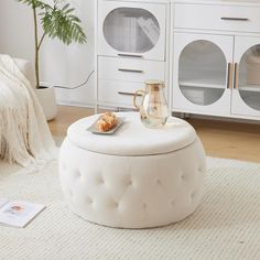 a white ottoman sitting on top of a rug