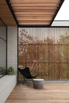 a black chair sitting on top of a wooden floor