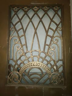 an ornate iron window in the corner of a building