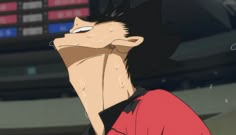 an anime character with black hair and red shirt staring at something in the air above his head