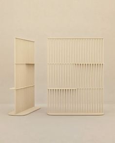 two white shelves sitting next to each other