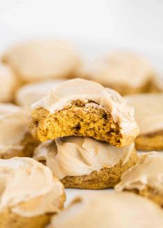 a cookie with frosting on it and some cookies in the background