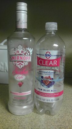 two bottles of water sitting on top of a counter