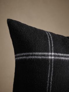 a black and white plaid pillow sitting on top of a table