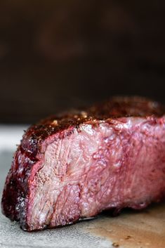 a piece of steak sitting on top of a cutting board