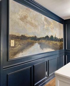 a painting is hanging on the wall above a kitchen counter