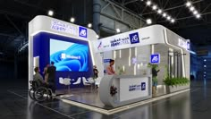 an exhibition stand with people standing around and one person in a wheel chair at the front