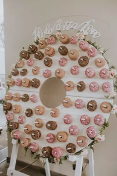 doughnuts are arranged on top of a sign for a donut shop display