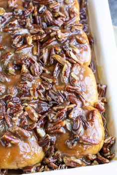 a casserole dish filled with pecans and caramel