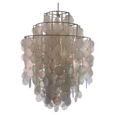 a chandelier made out of shells on a white background