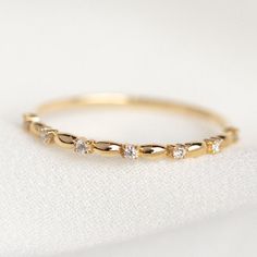 Round Diamond Band, 7 Stone Diamond Gold Band, Yellow Gold Ultra Thin Band, Stacking Diamond Band, Distance Diamond Band, Minimalist Micro Pave Band, Delicate Diamond Band, Wedding Engagement Ring, Anniversary Gift For Her, Promise Band, Birthday Gift, Handmade Unique Ring, Gift For Women, Trendy Jewelry For Girls ✤ 𝐂𝐄𝐍𝐓𝐄𝐑 𝐃𝐈𝐀𝐌𝐎𝐍𝐃: ↦ Shape: Round Cut  ↦ Color | Clarity: EF / VVS ↦ Carat Weight: 1.20 MM ↦ Stone Size: 0.70 Carat ↦ Stone Type: Moissanite / CZ Diamond ↦ Polish/Symmetry Womens Unique Wedding Bands, Decorative Wedding Band, Gold Ring With Small Diamond, 7 Diamond Wedding Band, Simple Women Wedding Band, Mixed Metal Wedding Ring Set, Stacked Bands With Engagement Ring, Gold Wedding Band With Oval Diamond, Wedding Band With Birthstone