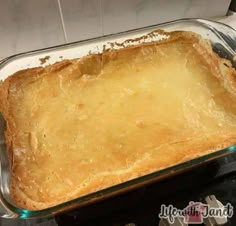 an uncooked casserole in a glass dish on top of a stove