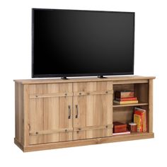 a flat screen tv sitting on top of a wooden cabinet