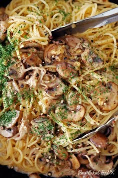 pasta with mushrooms and parsley in a skillet, ready to be eaten by someone