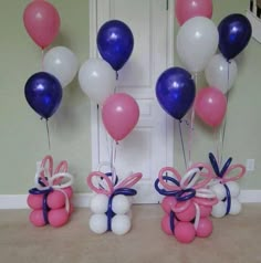 balloons and bows are tied to the wall in front of a door with an entry way