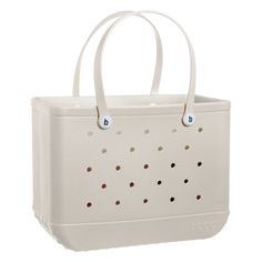 a white tote bag with dots on it