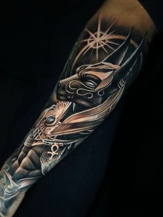 a man's arm with an artistic tattoo design on it