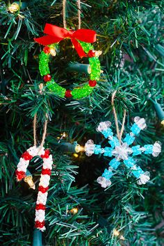 christmas ornaments are hanging from the tree