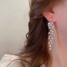 a close up of a person wearing some kind of earrings