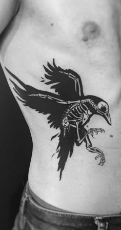 a black and white photo of a man's chest with a bird on it